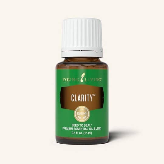 Clarity essential oil bottle with herbs for focus and productivity