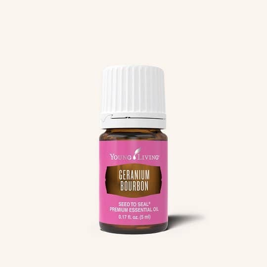 Geranium Bourbon essential oil with floral backdrop