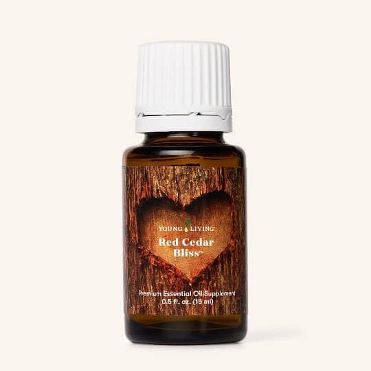 Red Cedar Bliss essential oil blend bottle with citrus, clove, and cedar.
