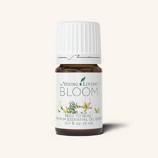 Bloom essential oil bottle with floral and spa background