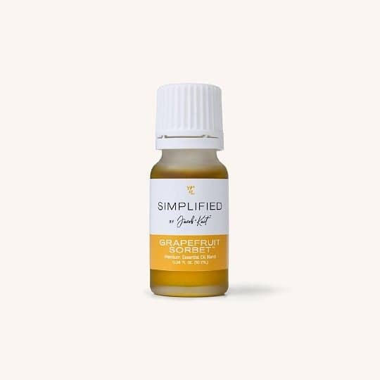Simplified by Jacob + Kait Grapefruit Sorbet essential oil bottle with citrus slices nearby
